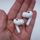 A photo of a person holding the AirPods Pro